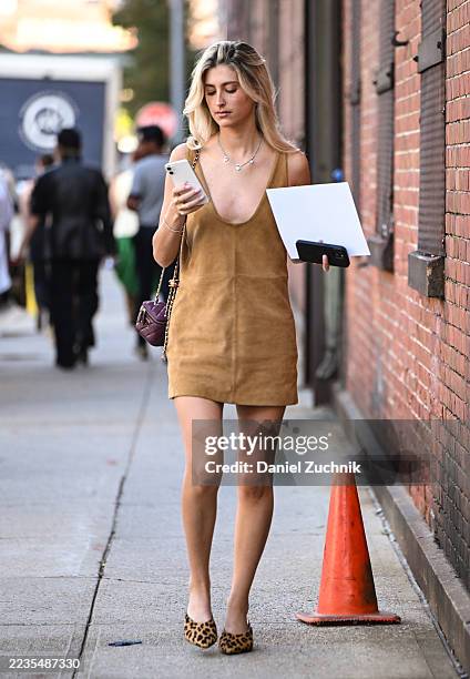 Guest is seen wearing a tan Jason Wu dress, animal print shoes and maroon bag outside the Jason Wu show during womenswear NYFW Spring 2026 on...