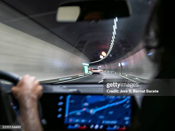 car's point of view, car moving inside a tunnel with vanishing point effect. - light at the end of the tunnel car stock pictures, royalty-free photos & images
