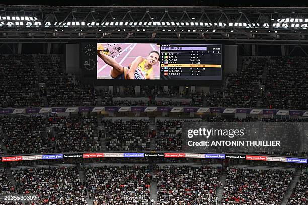 Germany's athlete Caroline Joyeux is seen on the big screen as she competes in the women's triple jump final during the World Athletics Championships...