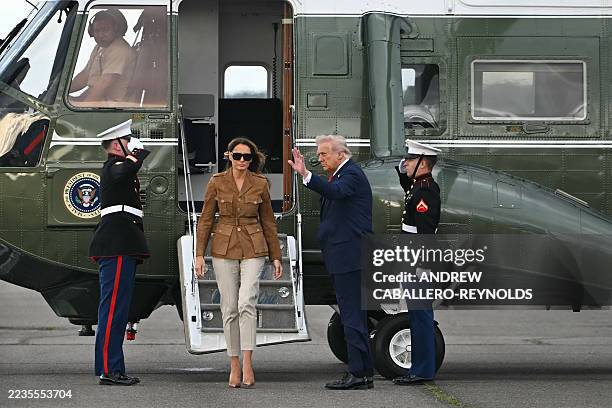 President Donald Trump and US First Lady Melania Trump walk across the tarmac from the Marine One helicopter toward Air Force One at Stansted...