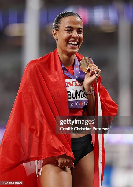 Gold medalist, Ditaji Kambundji of Team Switzerland, poses for a photo with her medal following victory in the Women's 100m Hurdles Final on day...