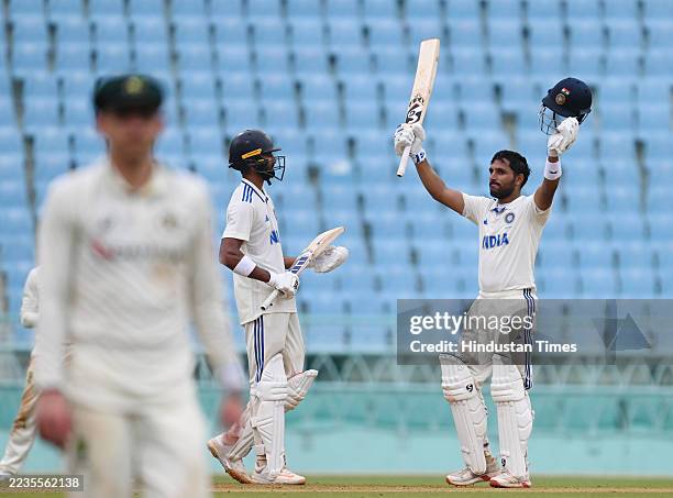 Dhruv Jurel of India A waves his bat to the crowd after completing his century against Australia A during the third day of 1st unofficial Test...