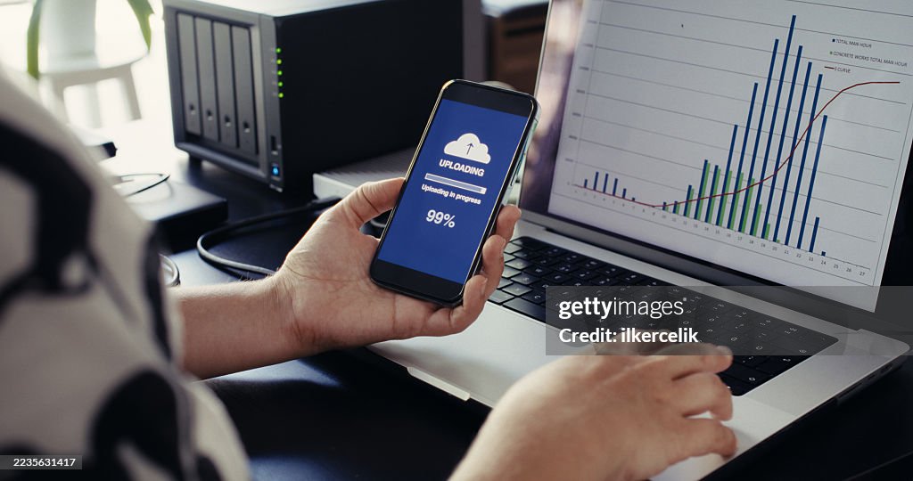 Woman uploading files to cloud using her smart phone