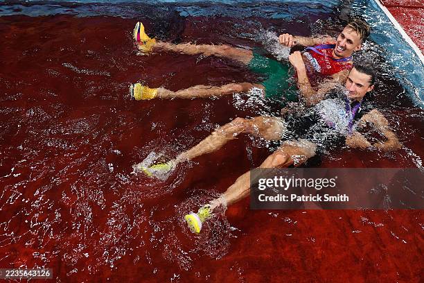 Gold medalist, Geordie Beamish of Team New Zealand, and silver medalist, Soufiane El Bakkali of Team Morocco, celebrate with their medals inside a...