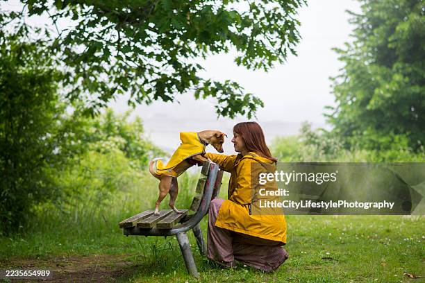 on the same level - raincoat stock pictures, royalty-free photos & images