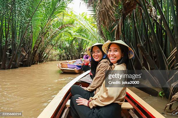 beautiful ladies enjoing boat tour in tropical river - vietnamese woman stock pictures, royalty-free photos & images