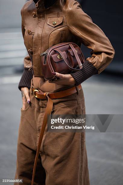 Sierra Renas wears brown bag, jacket, pants outside Coach during New York Fashion Week on September 15, 2025 in New York City.