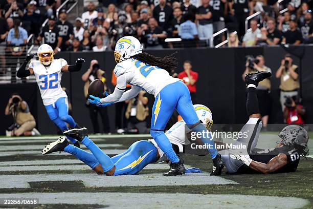 Donte Jackson intercepts a pass tipped by Derwin James Jr. #3 of the Los Angeles Chargers and intended for Jakobi Meyers of the Las Vegas Raiders...