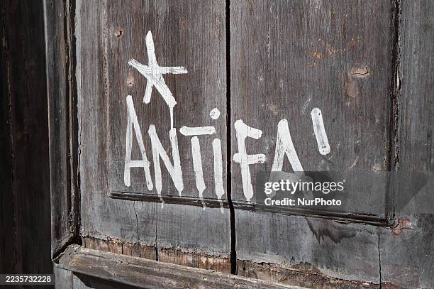 Close-up of graffiti reading ''Antifa'' is painted in white on the wooden door of a university building in Bari, Italy, on September 19, 2025.