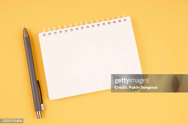 top view open blank notebooks and pen on yellow background. - note book mockup foto e immagini stock