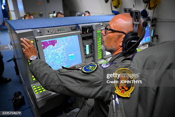 Tactical Director assesses the air and surface situation aboard an AWACS NATO air surveillance aircraft during a flight over Polish airspace as part...