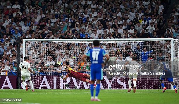 Geronimo Rulli of Olympique de Marseille fails to save a penalty from Kylian Mbappe of Real Madrid as he scores his team's first goal during the UEFA...