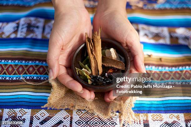 woman holding a bowl with incense for an andean ritual - traditional native american medicine stock pictures, royalty-free photos & images