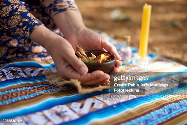 woman performing ancestral american ritual with burning herbs and candle - traditional native american medicine stock pictures, royalty-free photos & images