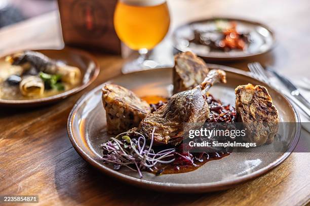 goose or duck leg with stewed red cabbage, karlovy vary dumplings and draft beer. - austrian culture stock pictures, royalty-free photos & images