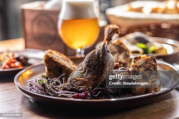 goose or duck leg with stewed red cabbage, karlovy vary dumplings and draft beer. - goose meat stock pictures, royalty-free photos & images