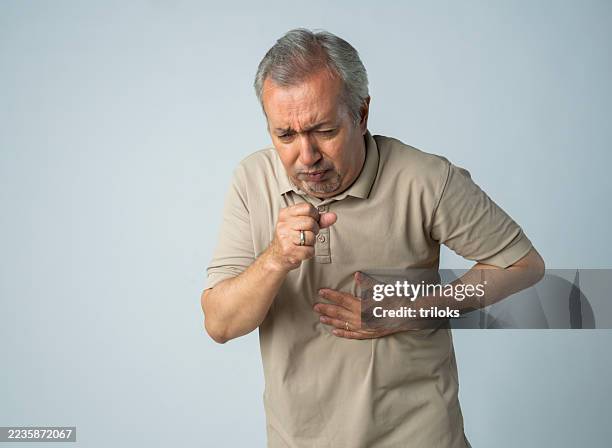 senior man suffering from cough against white background - bronchitis stock pictures, royalty-free photos & images