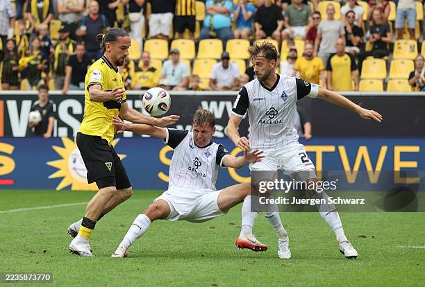 Valmir Sulejmani of Aachen battles for the ball with Sascha Voelcke of Mannheim and Lukas Kluenter of Mannheim during the 3. Liga match between...