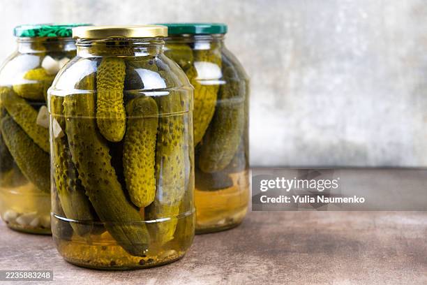 pickled cucumbers in jars. - cetriolino foto e immagini stock