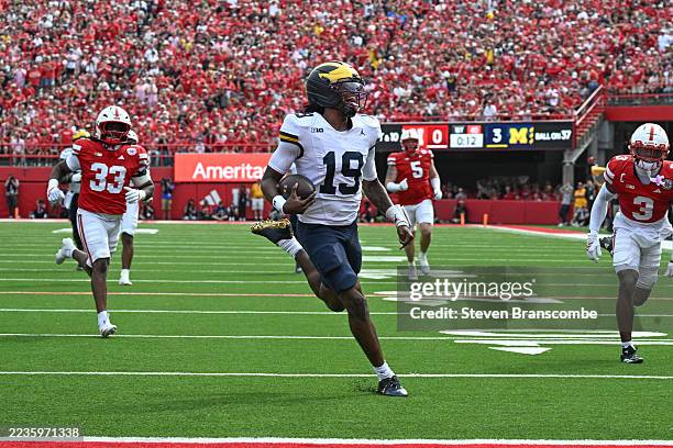 Bryce Underwood of the Michigan Wolverines runs from the Nebraska Cornhuskers to score during the first half at Memorial Stadium on September 20,...