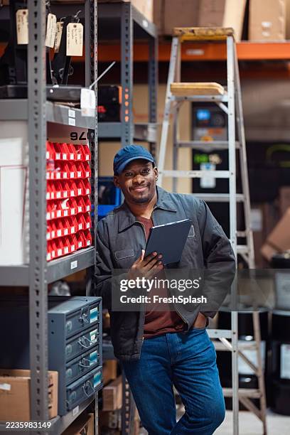 warehouse worker with digital tablet managing inventory and storage - safe place stock pictures, royalty-free photos & images