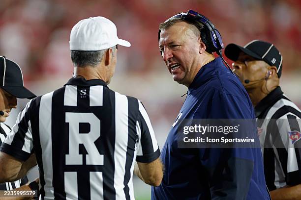 Head coach Bret Bielema of the Illinois Fighting Illini talks to officials on the sideline during a college football game against the Indiana...