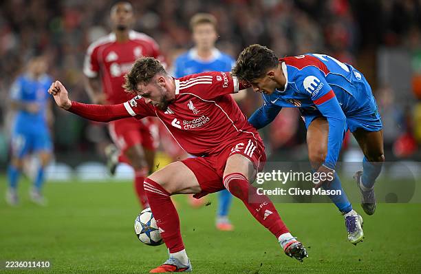 Conor Bradley of Liverpool is challenged by Giuliano Simeone of Atletico de Madrid during the UEFA Champions League 2025/26 League Phase MD1 match...