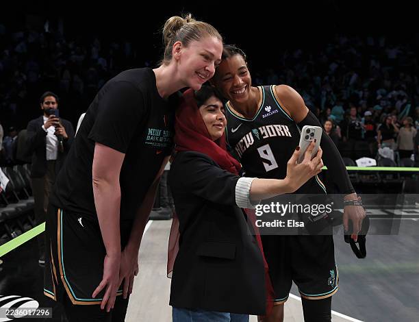 Emma Meesseman and Natasha Cloud of the New York Liberty pose with human rights activist Malala Yousafzai after Game Two of the first round of the...