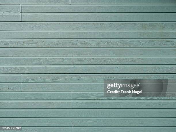 Horizontal wooden facade light gray-green with visible grain and pastel surface