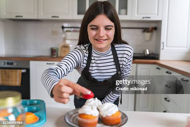 final touch – decorating cupcakes for cooking tutorial - muffin stock pictures, royalty-free photos & images