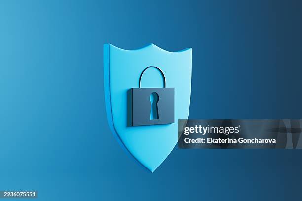 blue shield icon with lock representing cybersecurity and data protection - reliability stock pictures, royalty-free photos & images