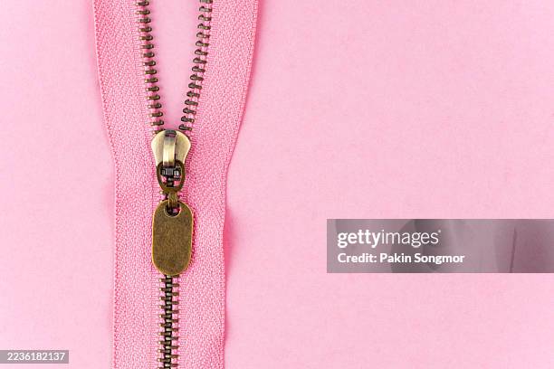 closeup of a pink color zipper on pink background, position with copy space. - zipper stock pictures, royalty-free photos & images