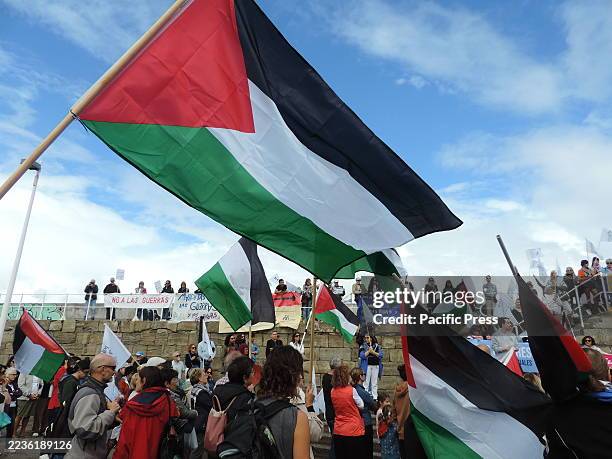 Demonstrators under the slogan 'No to wars' and coinciding with the International Day of Peace, march through the streets with Palestinian flags and...