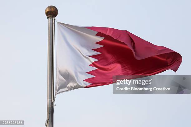 a qatari national flag - qatari flag stock pictures, royalty-free photos & images