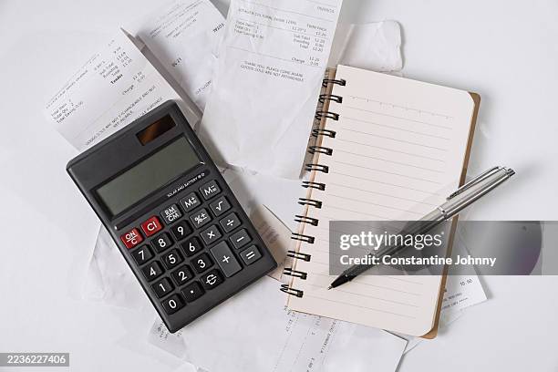 financial planning with calculator and receipts - tax time stock pictures, royalty-free photos & images