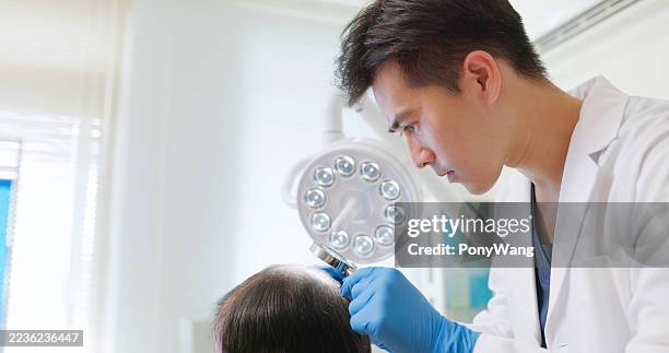 clinic doctor examining scalp - hairline polished metal stock pictures, royalty-free photos & images