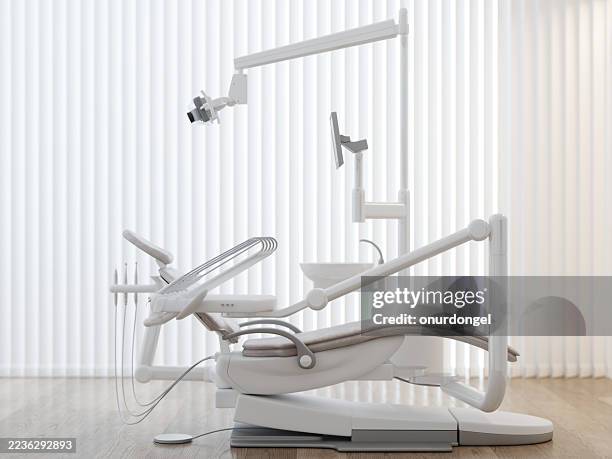 moderner zahnarztstuhl und ausstattung in einem hellen klinikraum - zahnarztstuhl stock-fotos und bilder