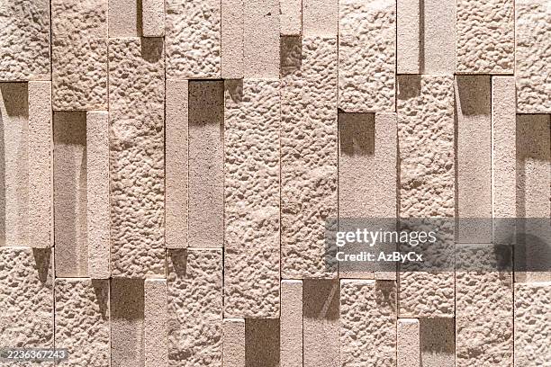a wall with a pattern of white bricks - sandstone tiles stock pictures, royalty-free photos & images