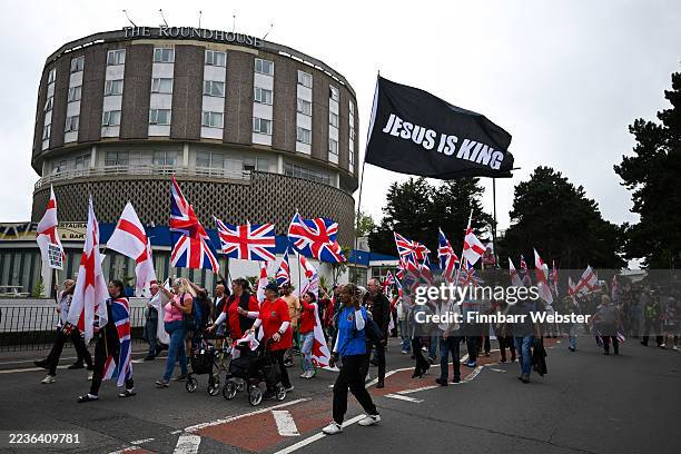 Anti-migrant protesters take part in a 'Bournemouth Patriots' march to the Roundhouse Hotel, on September 20, 2025 in Bournemouth, England. Far-right...