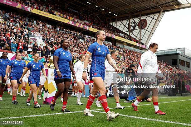 Marine Menager of France and Morwenna Talling of England walk out onto the pitch prior to the Women's Rugby World Cup 2025 Semi Final match between...