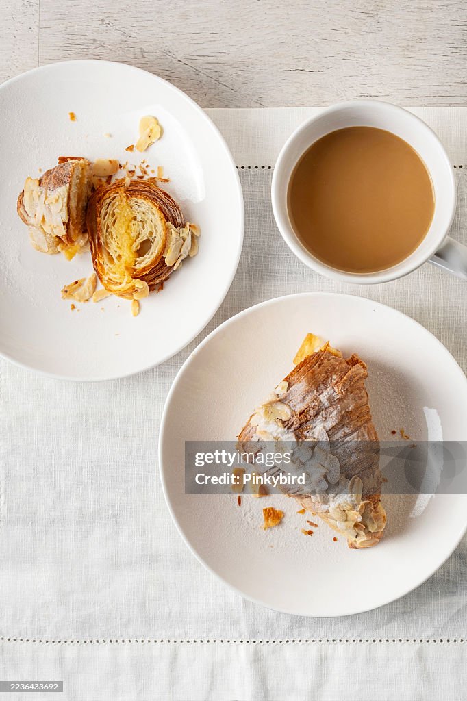 Croissant. Almond croissant. Almond puff pastry sweet dessert fresh delicious. Traditional French breakfast with gold and crispy croissants. Freshly Baked Almond Croissant With Cafe.