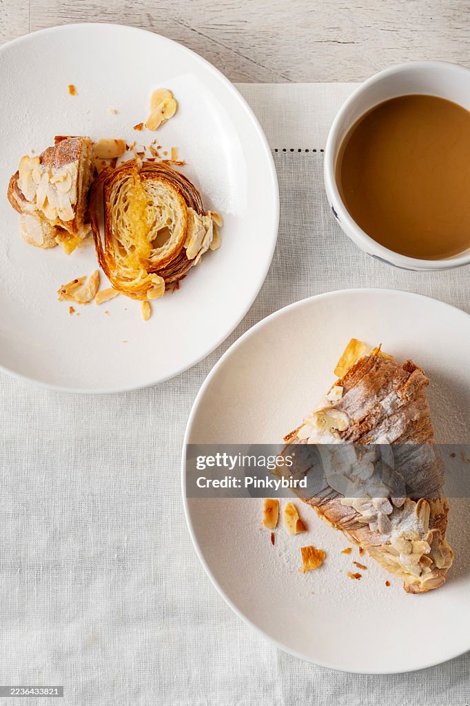 Croissant. Almond croissant. Almond puff pastry sweet dessert fresh delicious. Traditional French breakfast with gold and crispy croissants. Freshly Baked Almond Croissant With Cafe.