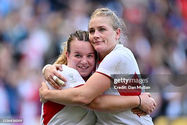 Lark Atkin-Davies and Alex Matthews of England embrace following victory in the Women's Rugby World Cup 2025 Semi Final match between France and...