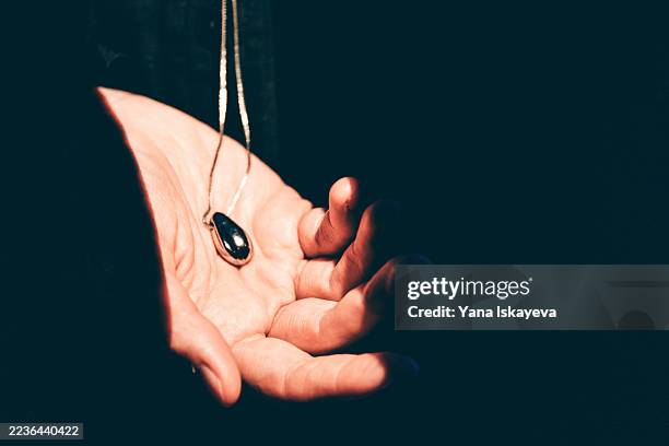 futuristic wearable necklace as personal technology and digital spirituality - schmuckanhänger stock-fotos und bilder