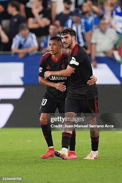 Alexis Sanchez of Sevilla FC celebrates scoring his team's second goal with teammate Isaac Romero during the LaLiga EA Sports match between Deportivo...