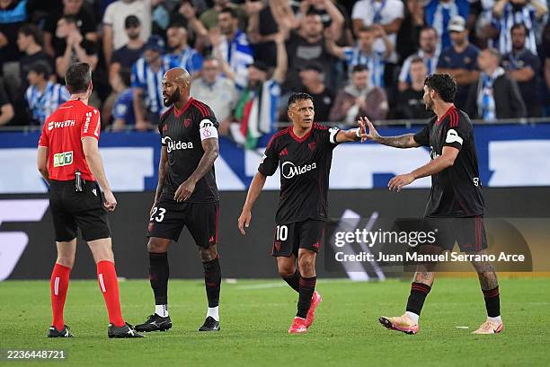 Alexis Sanchez of Sevilla FC celebrates scoring his team's second goal with teammate Isaac Romero during the LaLiga EA Sports match between Deportivo...