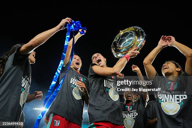 Kayla Sharples of Kansas City Current and teammates celebrate with the Shield after the NWSL match between Kansas City Current and Seattle Reign at...