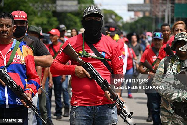 Armed civilians participate in a military deployment in support of Venezuela's President Nicolas Maduro at Bolivar Avenue in Caracas on September 23,...