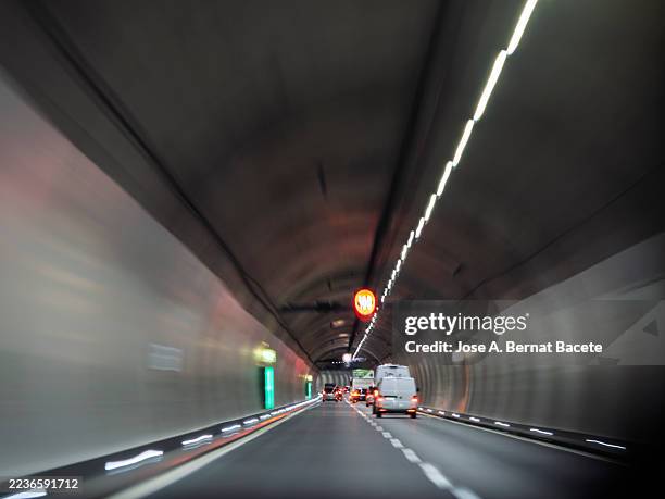 car's point of view, sensation of speed with cars on the road inside a moving tunnel. - light at the end of the tunnel car stock pictures, royalty-free photos & images