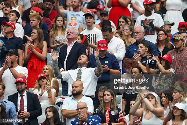 Attendees await the start of the memorial service for political activist Charlie Kirk at State Farm Stadium on September 21, 2025 in Glendale,...